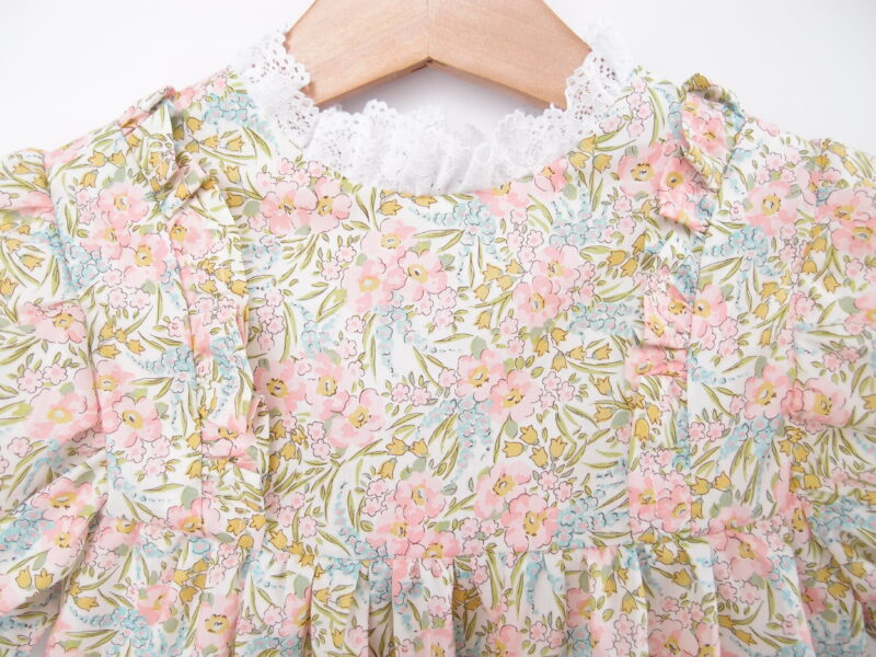 front of girl dress with ruffles and lace light pink flowers liberty fabric