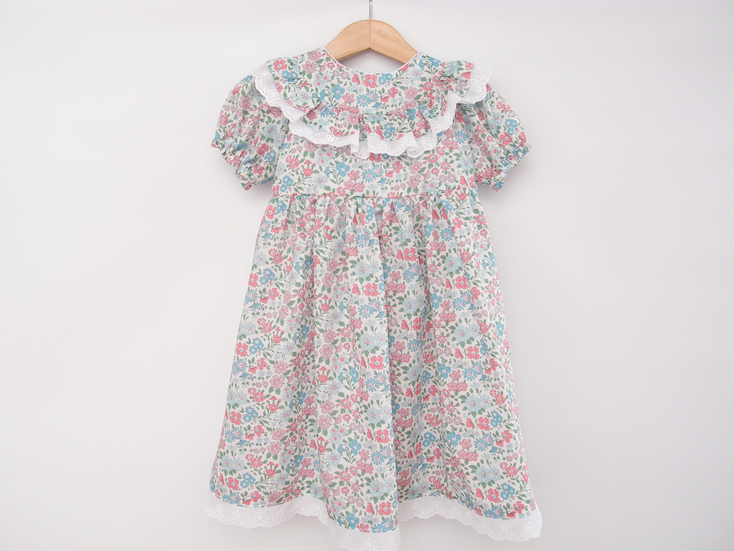 toddler girl dress with ruffle at the front and embroidered lace handmade