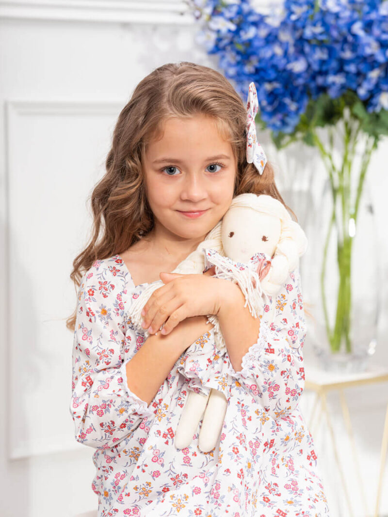girl with handmade cloth doll matching dress