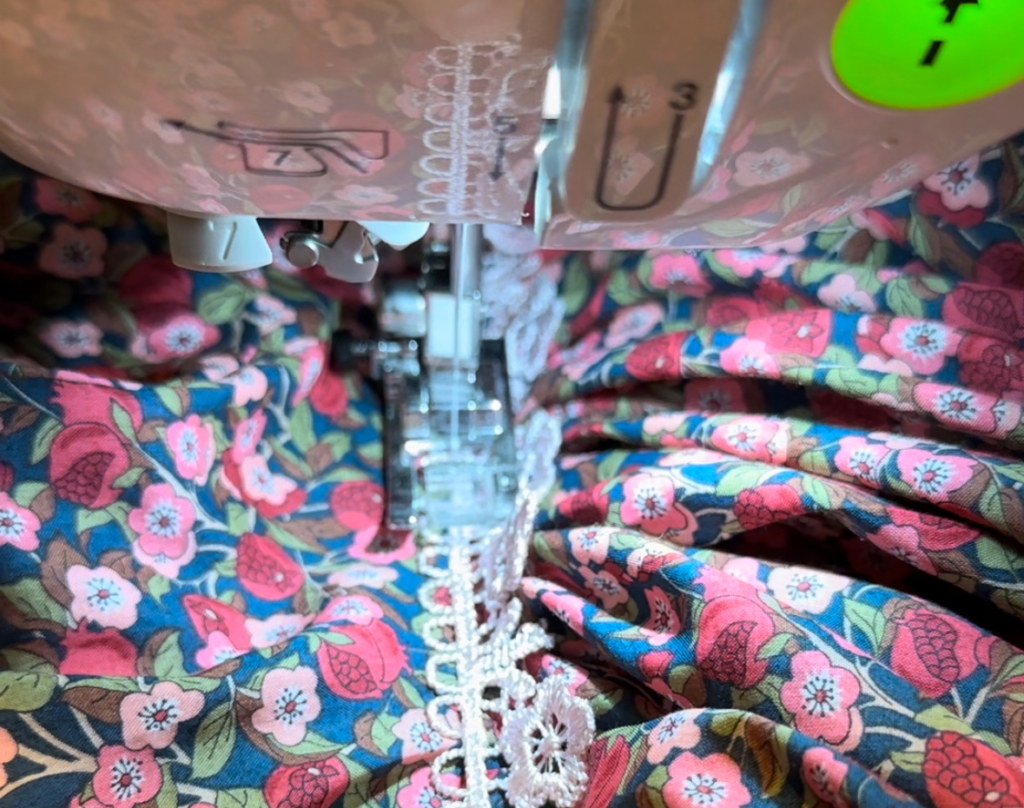 sewing pink lace to the girl dress