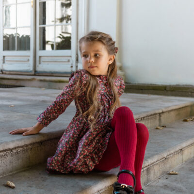 girl sitting on stairs wearing burgundy dress for autumn tana lawn cotton