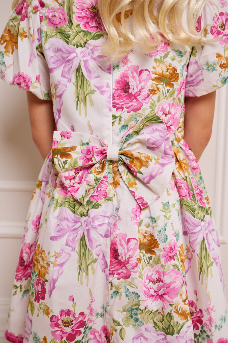 bow at the back of traditional floral pink childrens dress