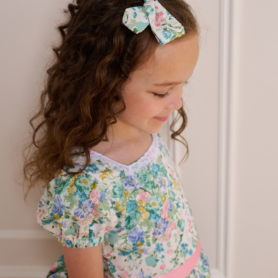 girl wearing floral hair bow made with liberty of london fabric