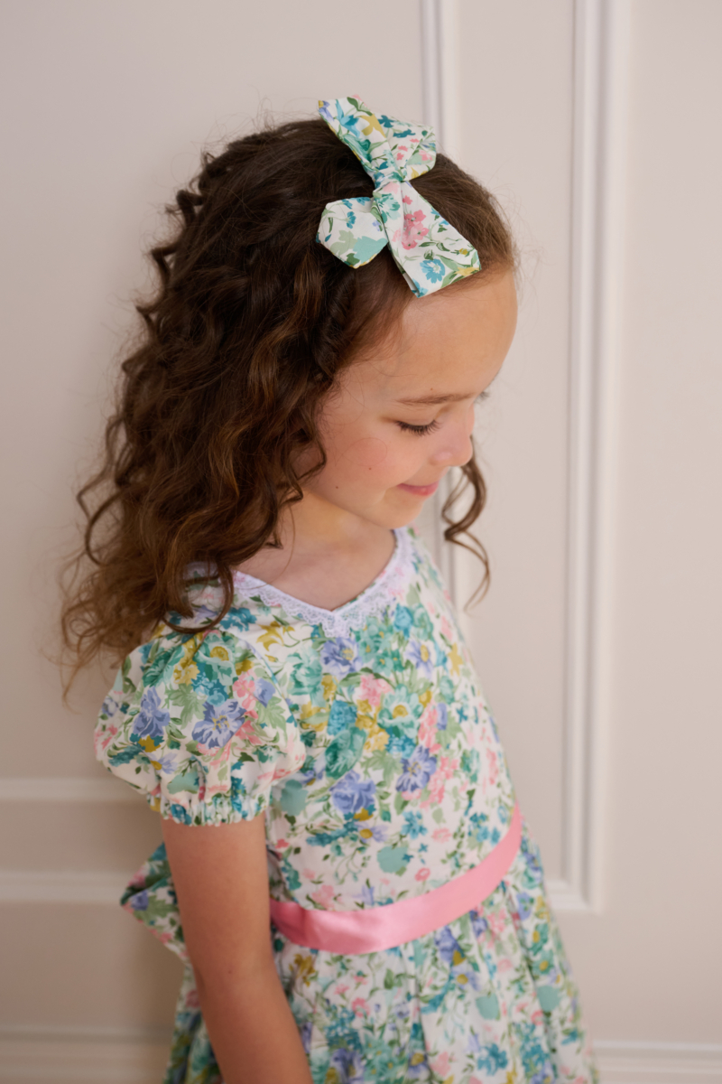 girl wearing floral hair bow made with liberty of london fabric