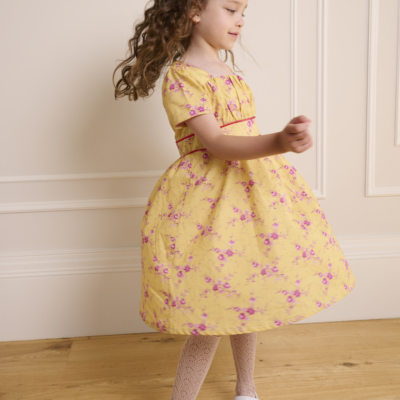 girl spinning in yellow dress sewn from liberty of london cotton