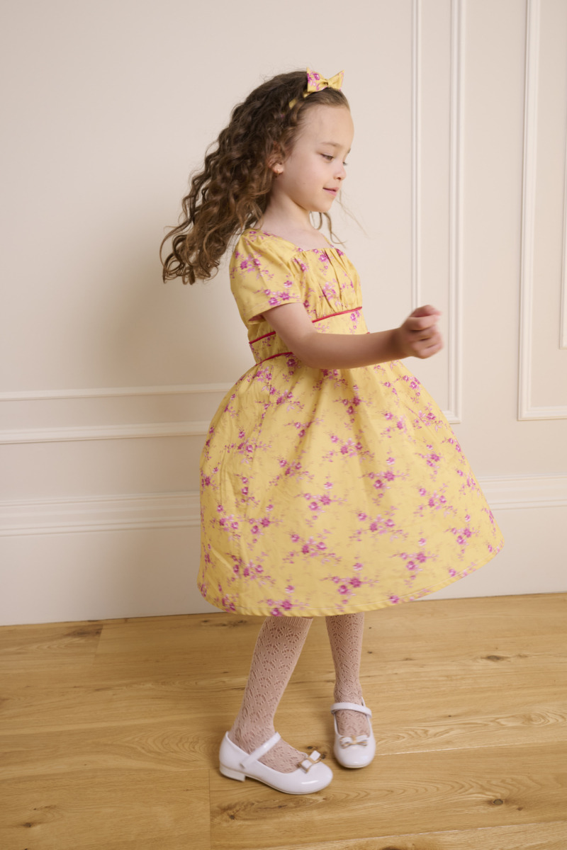 girl spinning in yellow dress sewn from liberty of london cotton