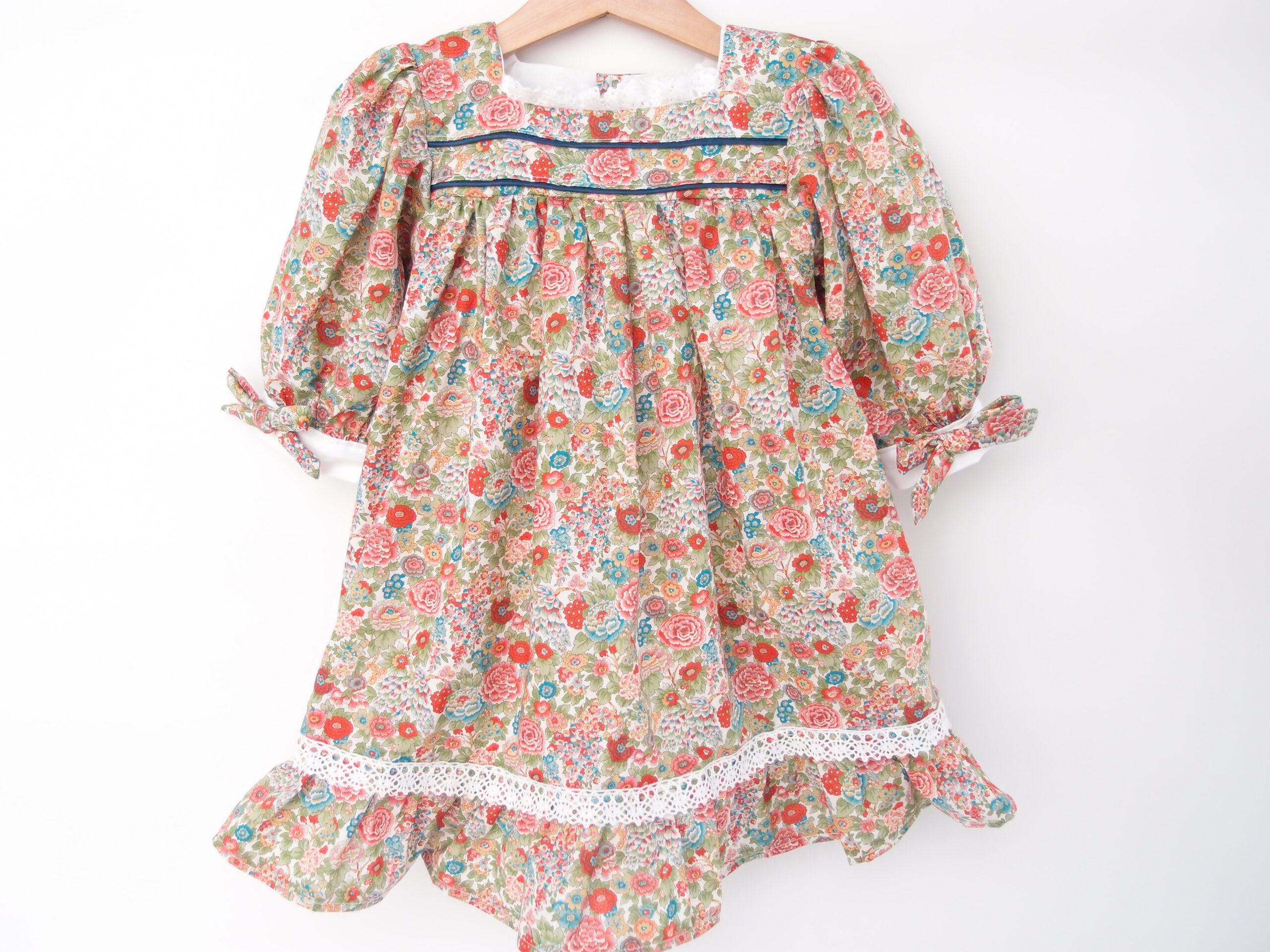 floral girl dress with long sleeves and bows and white lace